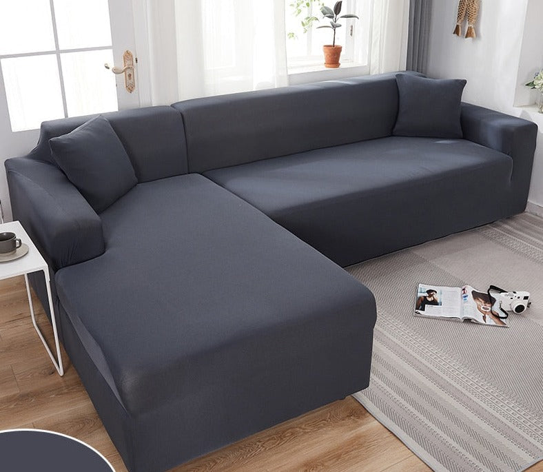 Dark grey stretch sofa cover installed neatly on a modern sectional couch