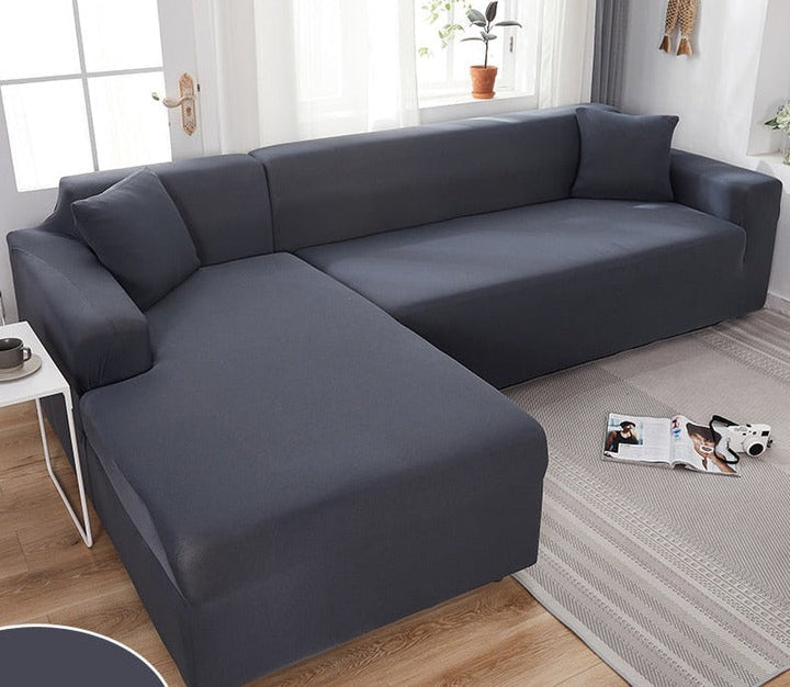 Dark grey stretch sofa cover installed neatly on a modern sectional couch