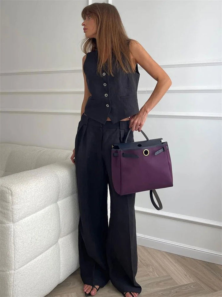 Flat lay of the complete vest and pleated pants ensemble