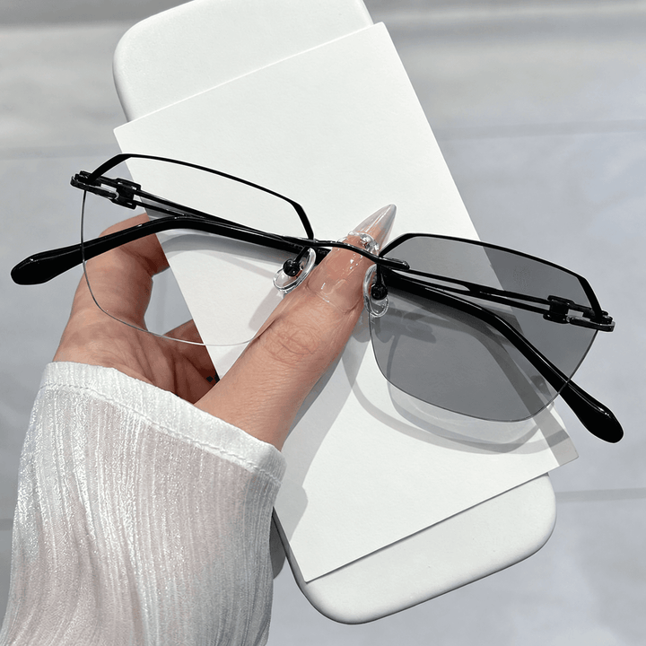 Top-down flat lay of mens multi-focus reading glasses and cleaning cloth