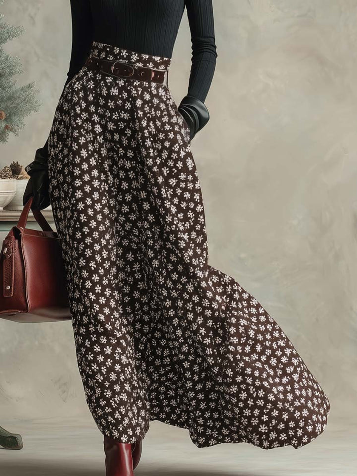 Close-up of the patterned skirt and tailored waistband in black and brown