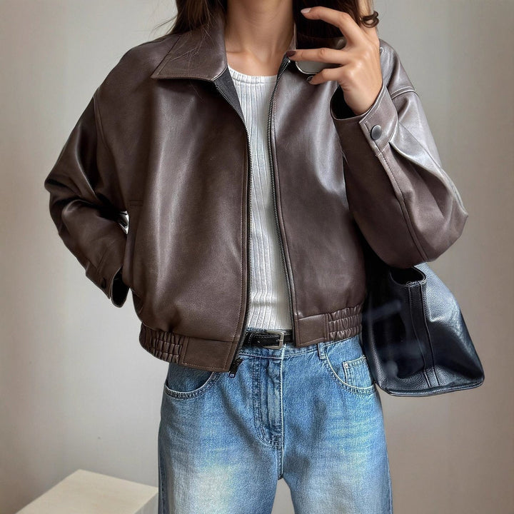 Close-up of woman in dark brown bomber jacket front view