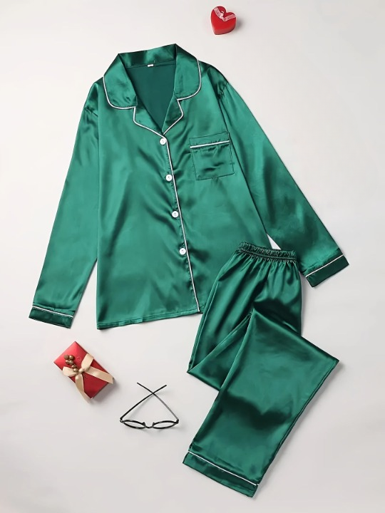 Green two-piece sleepwear set laid out flat with accessories