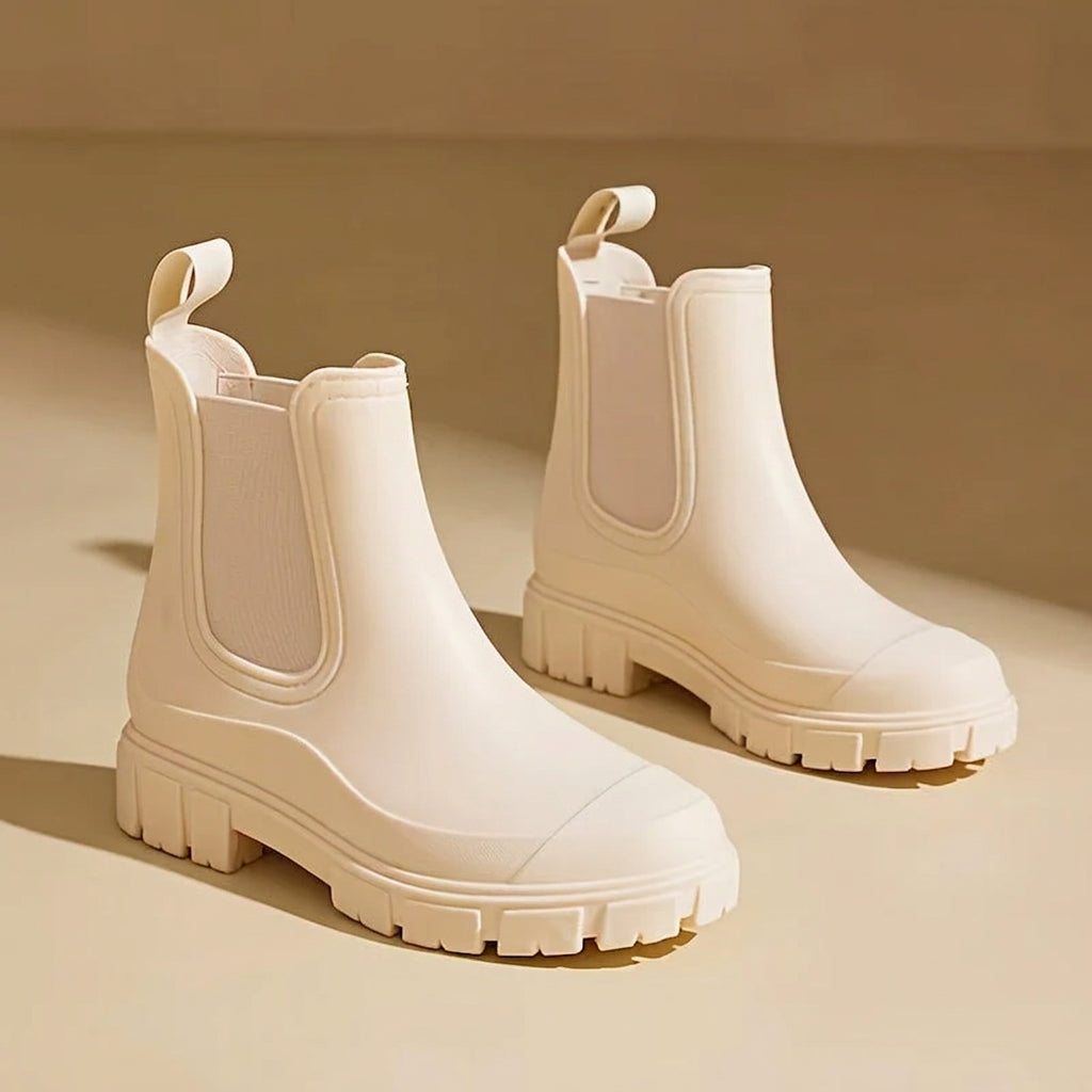 Pair of beige waterproof rain boots displayed against a neutral background