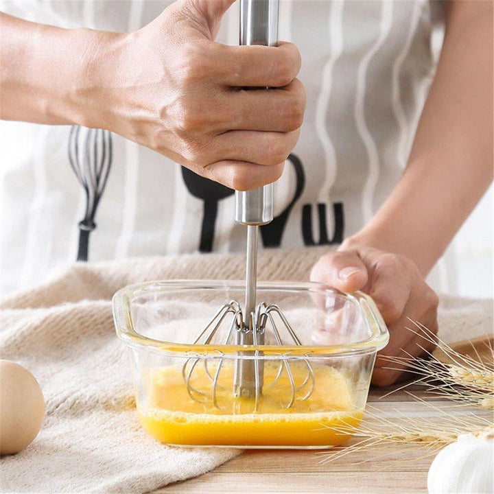Baking tool stainless steel whisk resting on kitchen counter