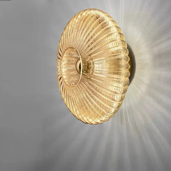 Minimalist interior wall lamp with brass accents and white glass shade