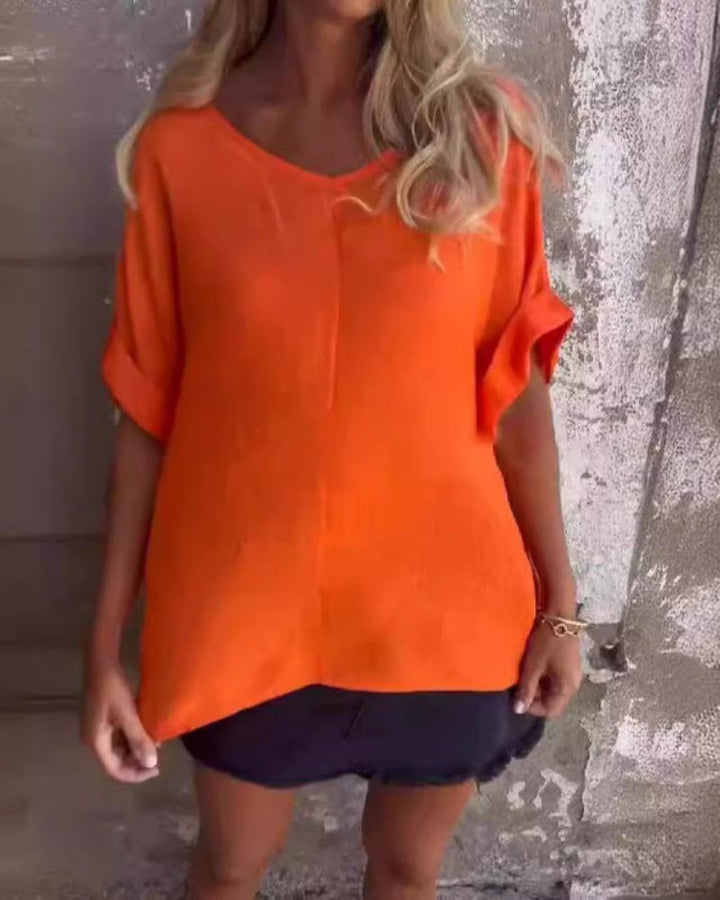 Close-up of the soft fabric texture and V-neckline of the short sleeve summer top.