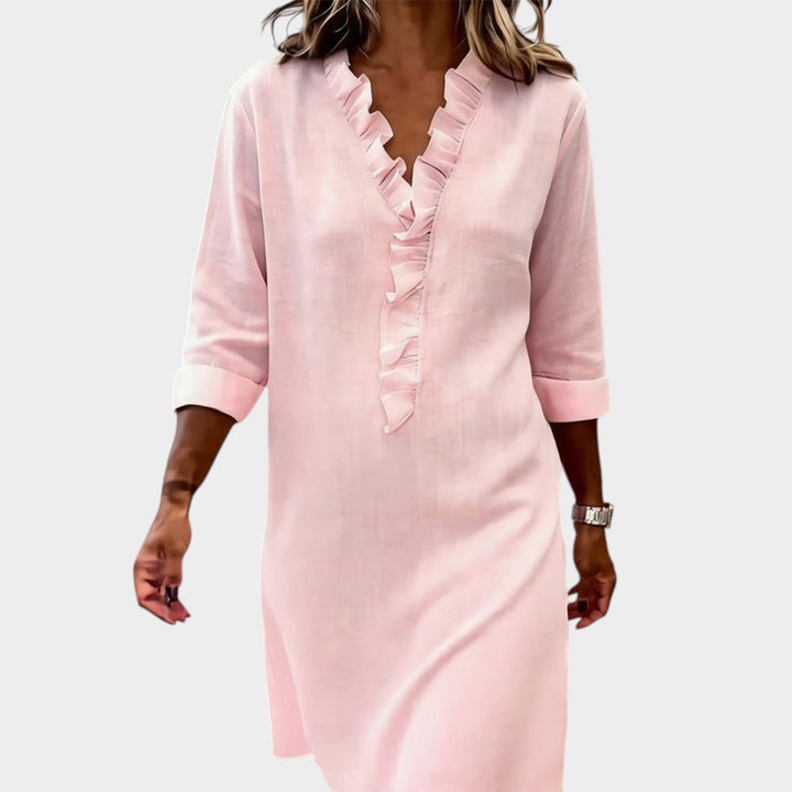 Close-up of woman in a pink ruffle V-neck dress