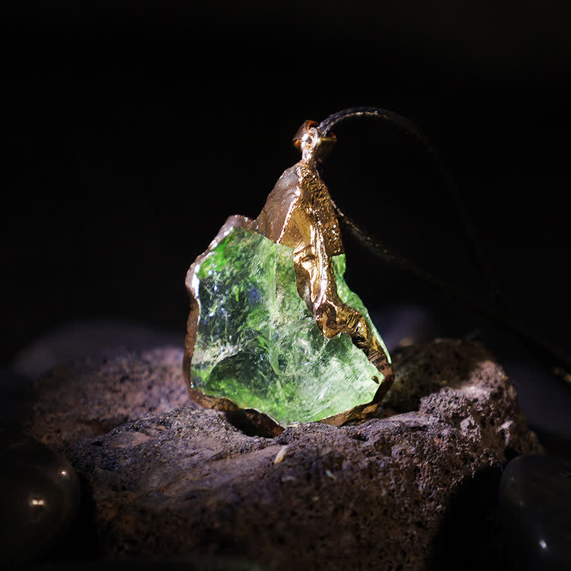Close-up of the natural Moldavite gemstone pendant showcasing unique texture