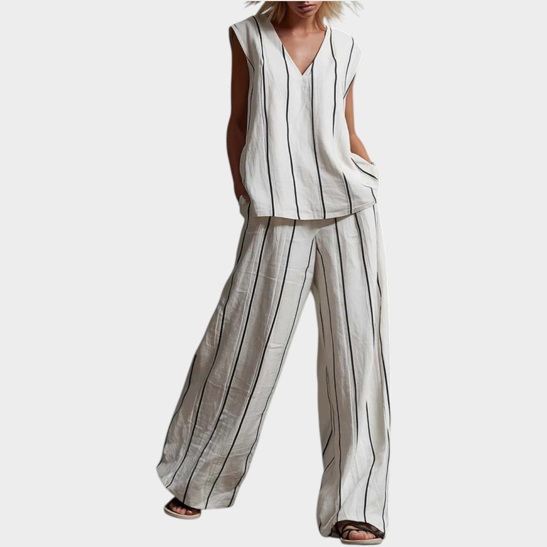 Front view of a woman wearing a white and black striped two-piece outfit with wide-leg pants