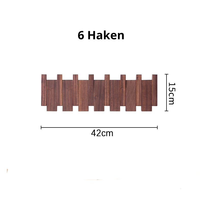 Close up of wooden coat hooks on a wall mount entryway storage rack