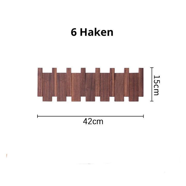 Close up of wooden coat hooks on a wall mount entryway storage rack