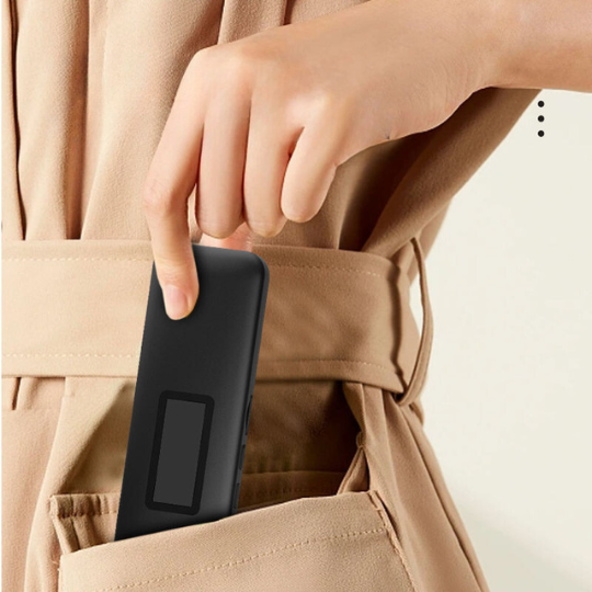 Black under pillow speaker held near pocket for size reference