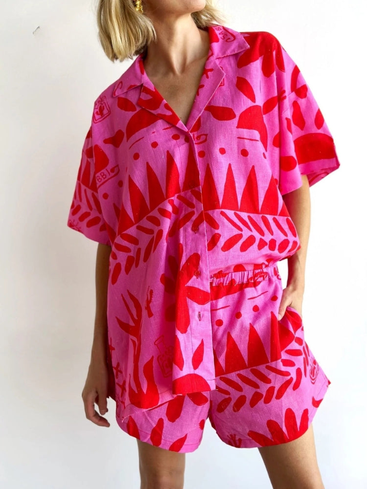 Woman wearing pink short sleeve button-up shirt and matching shorts