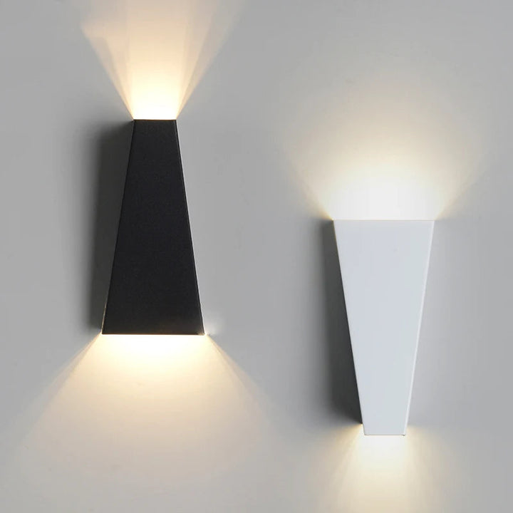 Black and white designer wall lamps displayed against a neutral background