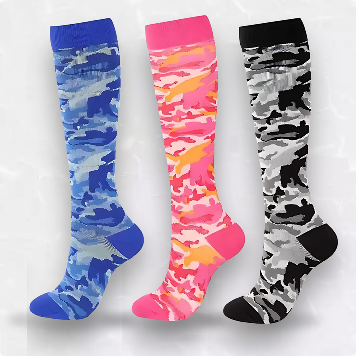 Three pairs of camo compression socks in blue, pink, and black