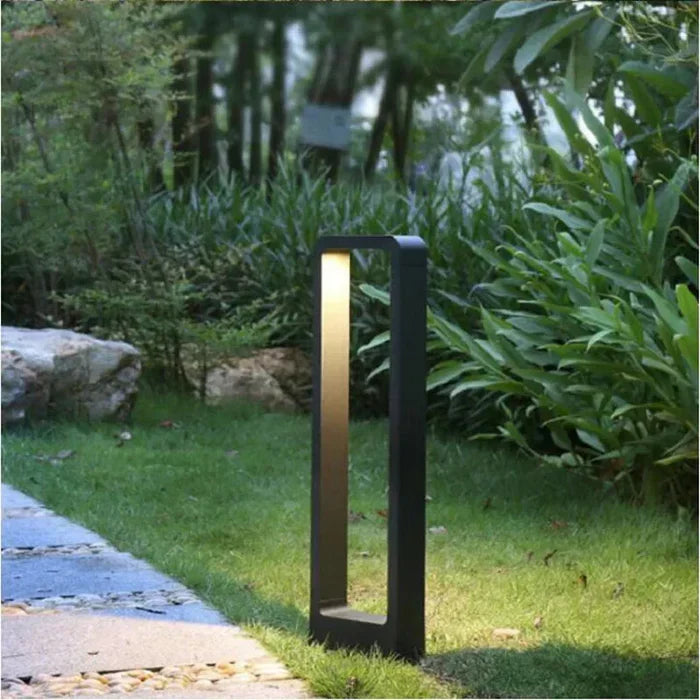 TerraBeam rugged outdoor LED ground spotlight casting warm light on garden pathway