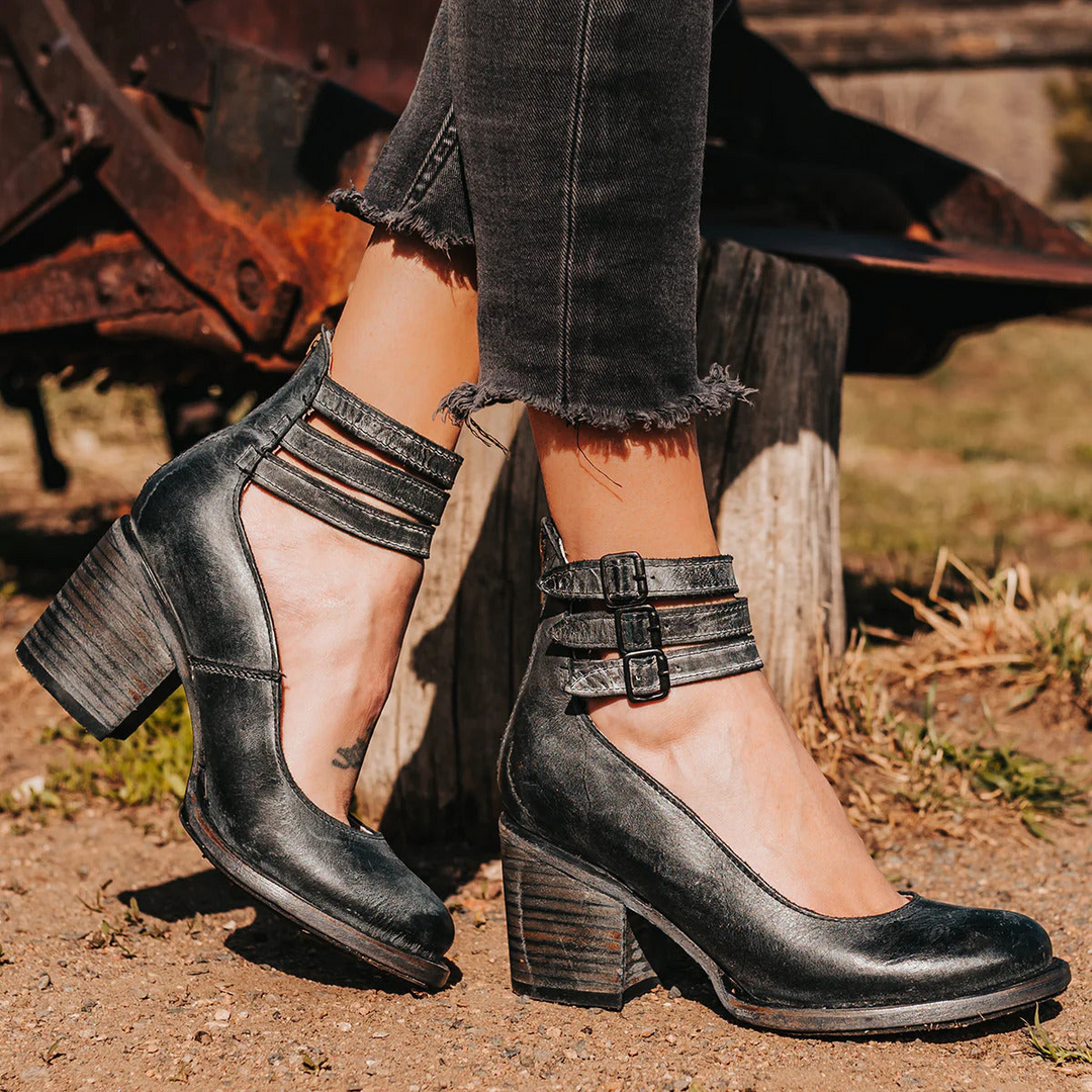 Black classic strap heels paired with cropped denim pants outdoors