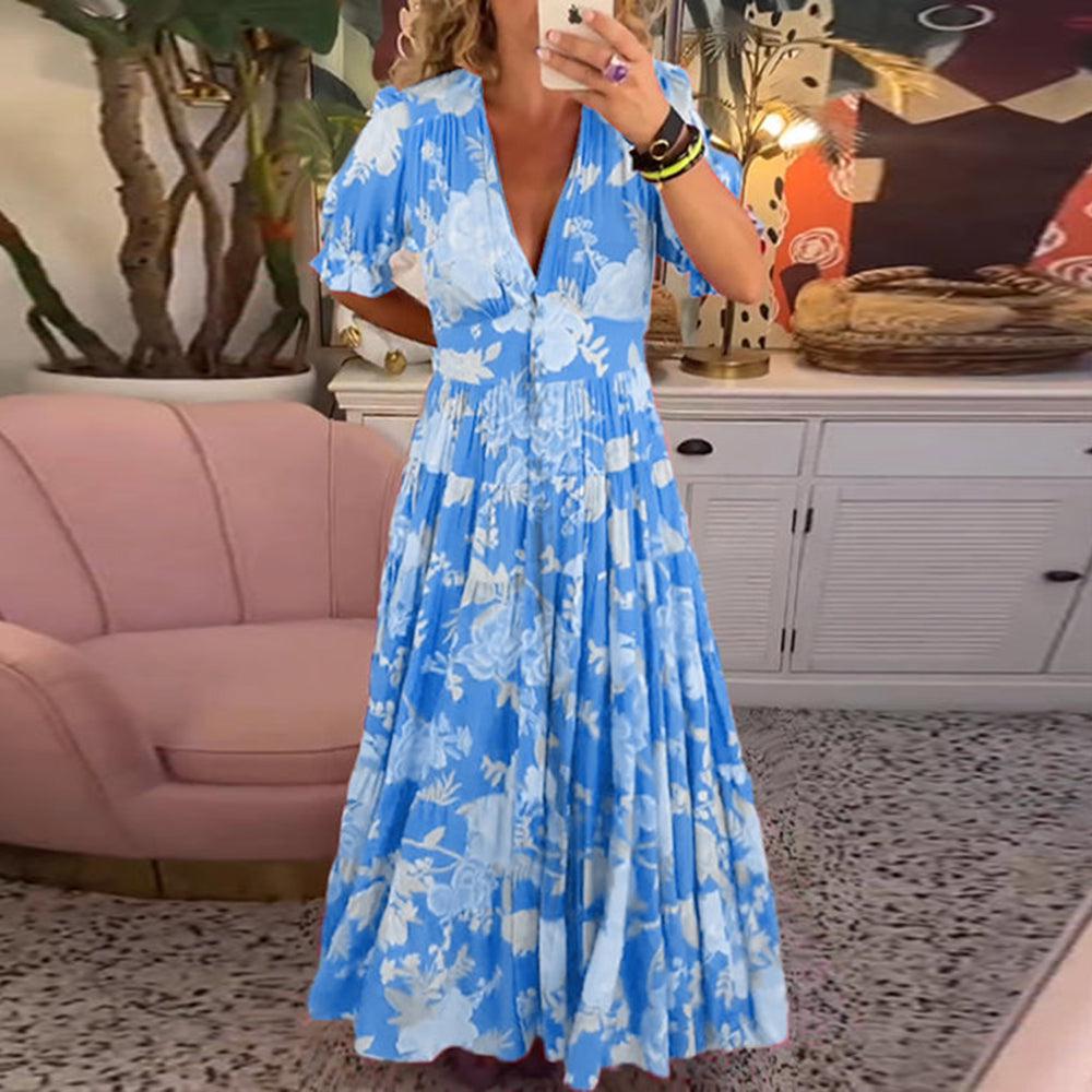 Model showcasing a bright blue floral maxi dress indoors