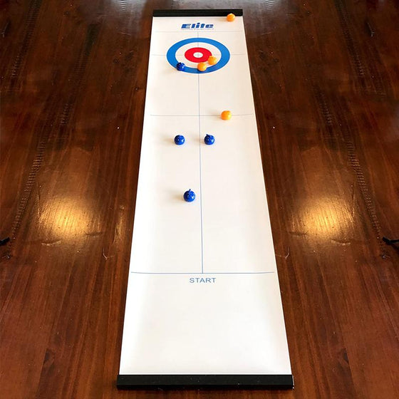 Mini tabletop curling game mat laid out on a wooden surface with colored stones