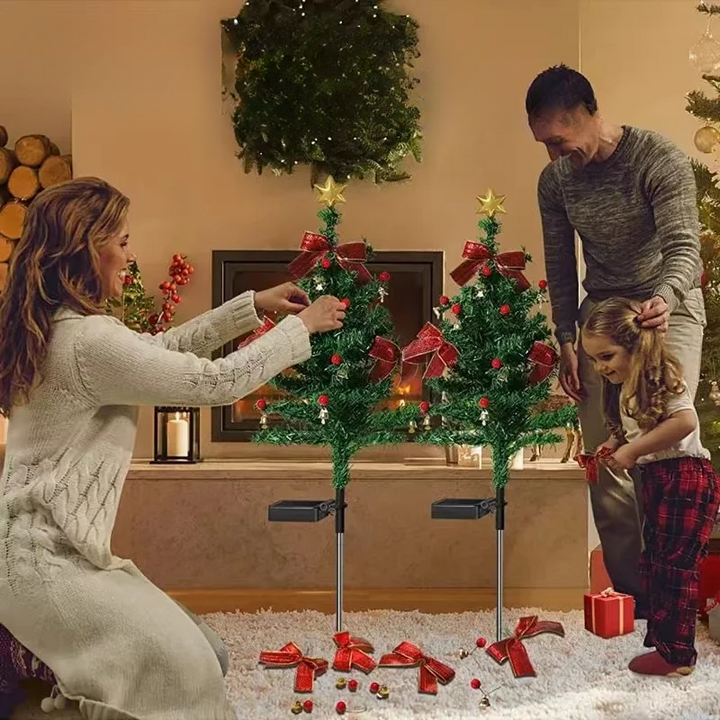 Family decorating solar Christmas tree garden lights indoors