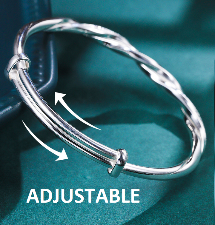 Close-up of geometric adjustable silver bracelet showing the twist detail
