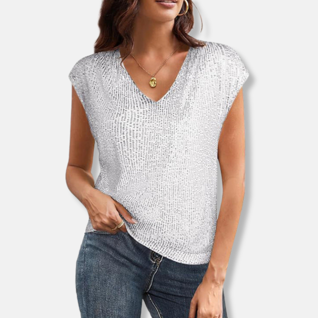 Close-up of festive party blouse featuring shimmering sequins and elegant V-neckline