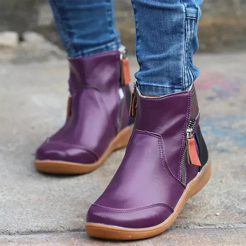 Women's boots detail shot focusing on side zipper and adjustable waterproof closure