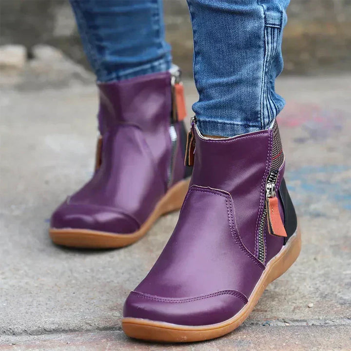 Women's boots detail shot focusing on side zipper and adjustable waterproof closure