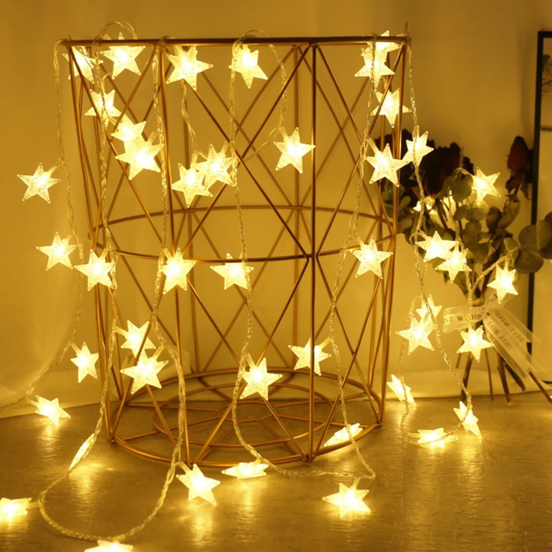 Warm white star string lights displayed inside a gold decorative wire basket