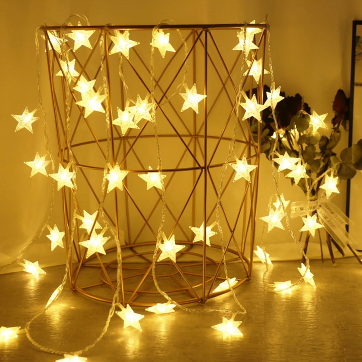 Warm white star string lights displayed inside a gold decorative wire basket