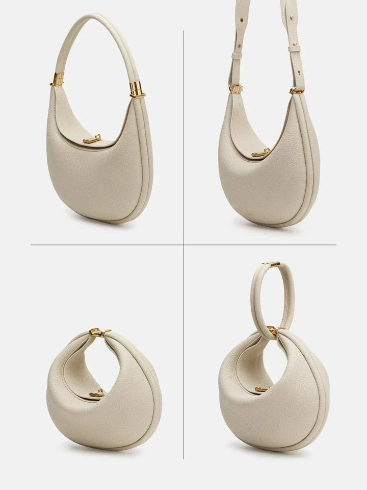 Close-up view of the ivory crescent crossbody bag showcasing hardware and texture