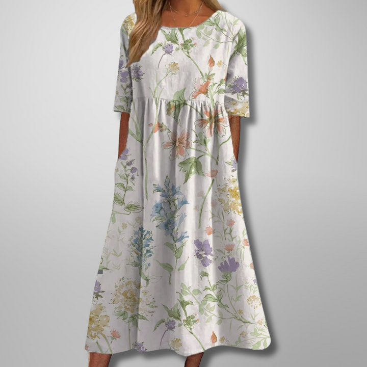 Women's floral midi dress showing short sleeves and botanical print fabric