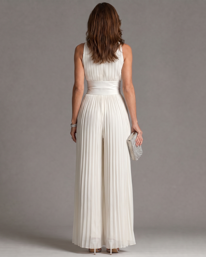 Full length view of stylish pleated wedding guest jumpsuit in solid white