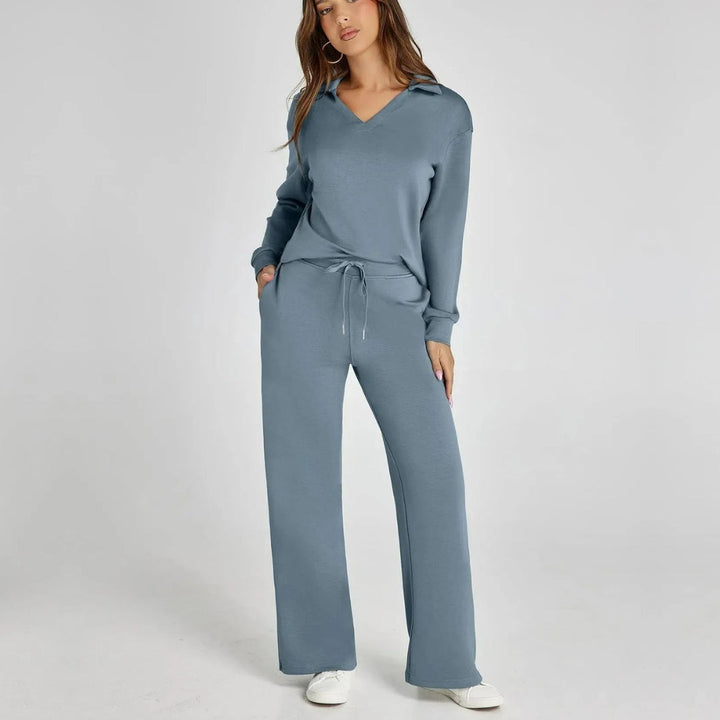 Model wearing light blue women's V-neck loungewear set with wide trousers