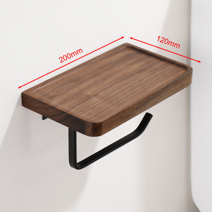 Wooden toilet paper holder with phone shelf mounted on a bathroom wall