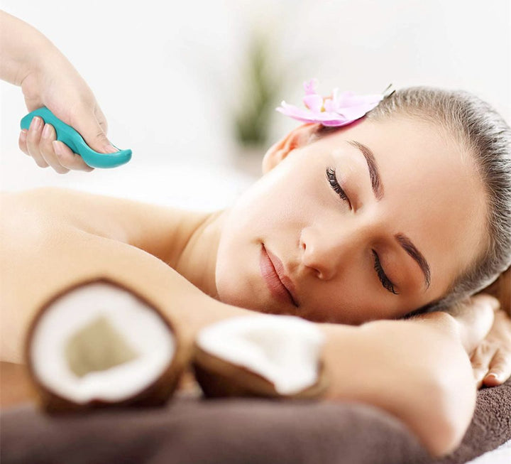 Professional deep tissue massage tool being used on a client's back