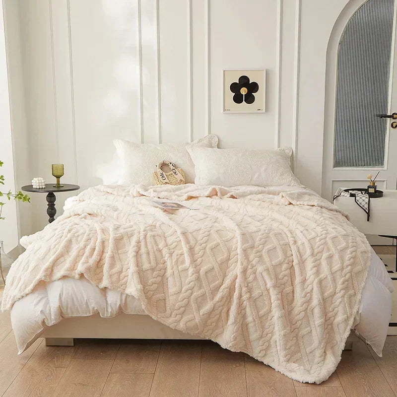 Soft plush blanket spread across bed for ultimate winter warmth and comfort