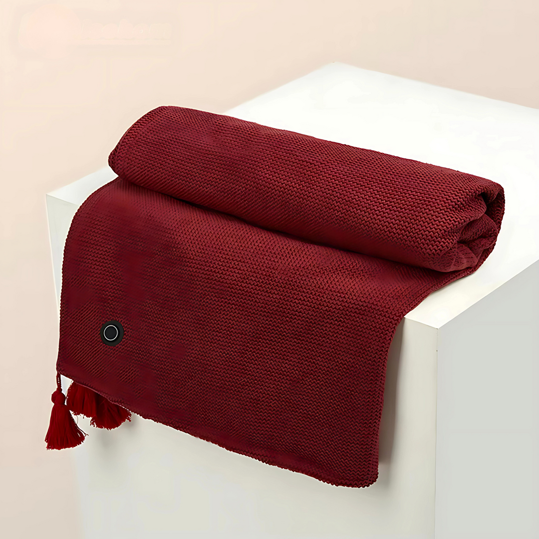Red cordless USB heated shawl folded neatly with tassel detail on a display stand