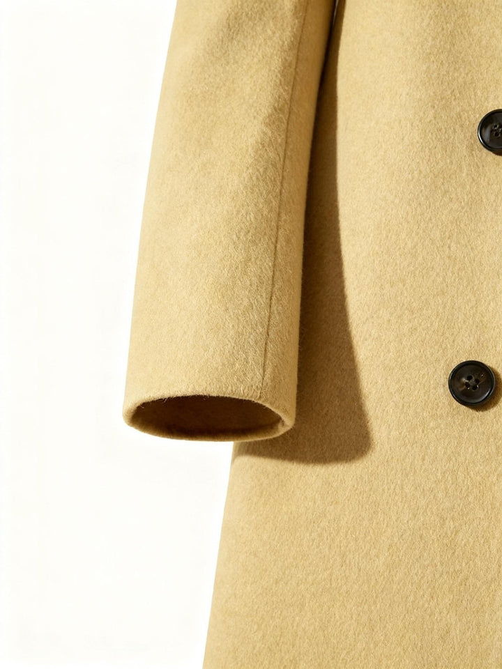 Casual styling of the men's long coat paired with a sweater and denim jeans.