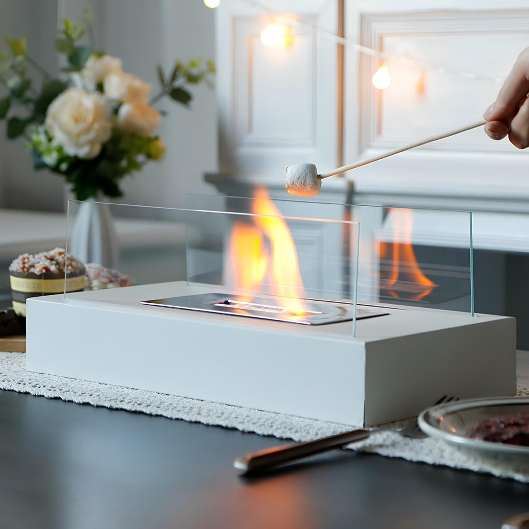 Portable fire pit and glass tabletop fireplace creating cozy ambiance indoors