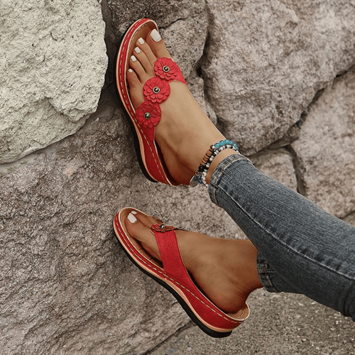 Close-up of decorative flower detail on comfortable summer wedge shoes