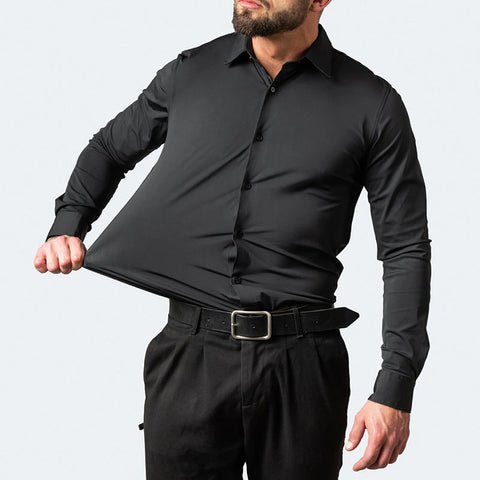 Man demonstrating the stretch fabric of a black long-sleeve dress shirt