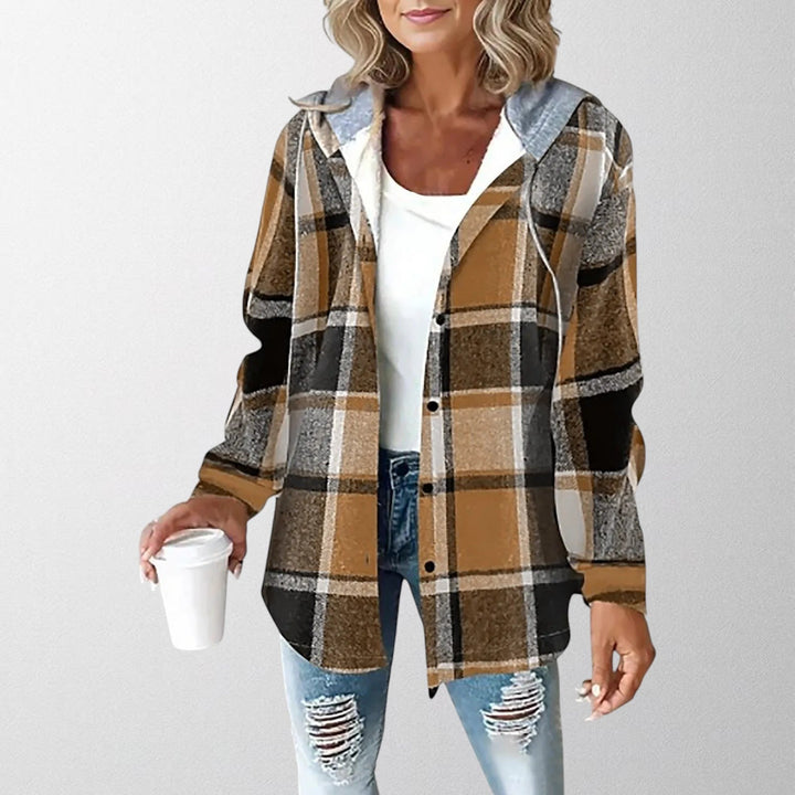 Close-up view of plaid pattern and warm hood on women's jacket