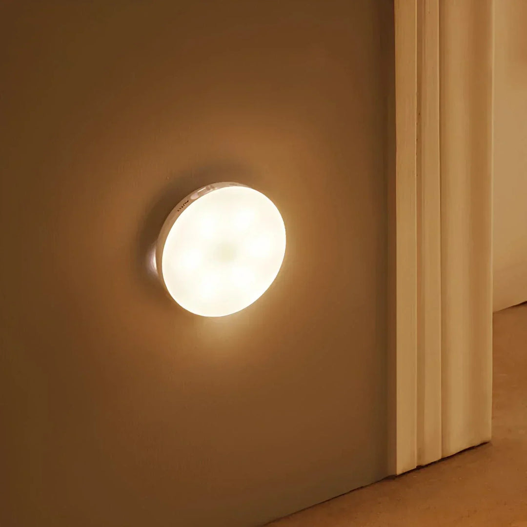 Compact wireless night light showing bright illumination in a bedroom