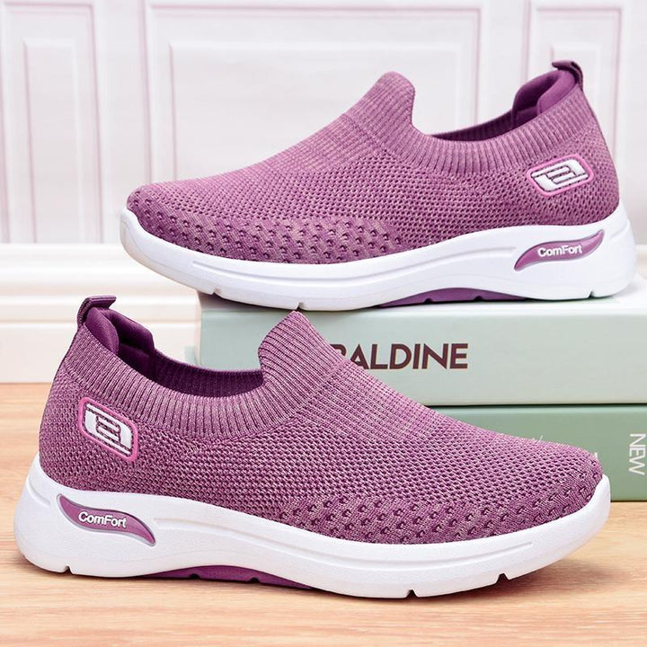 Purple women's orthopedic sports walking shoes displayed on a shelf