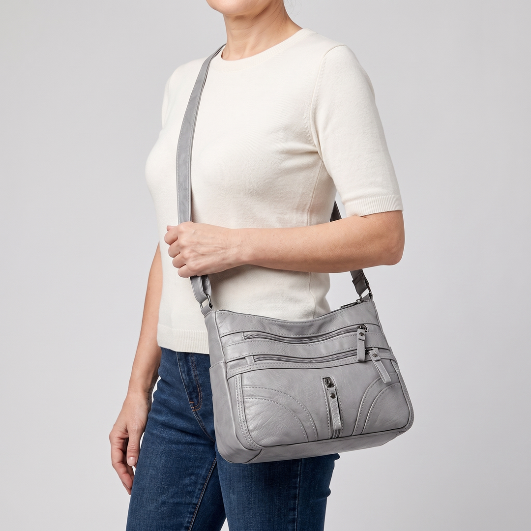 Model wearing a gray vintage crossbody tote bag with adjustable strap