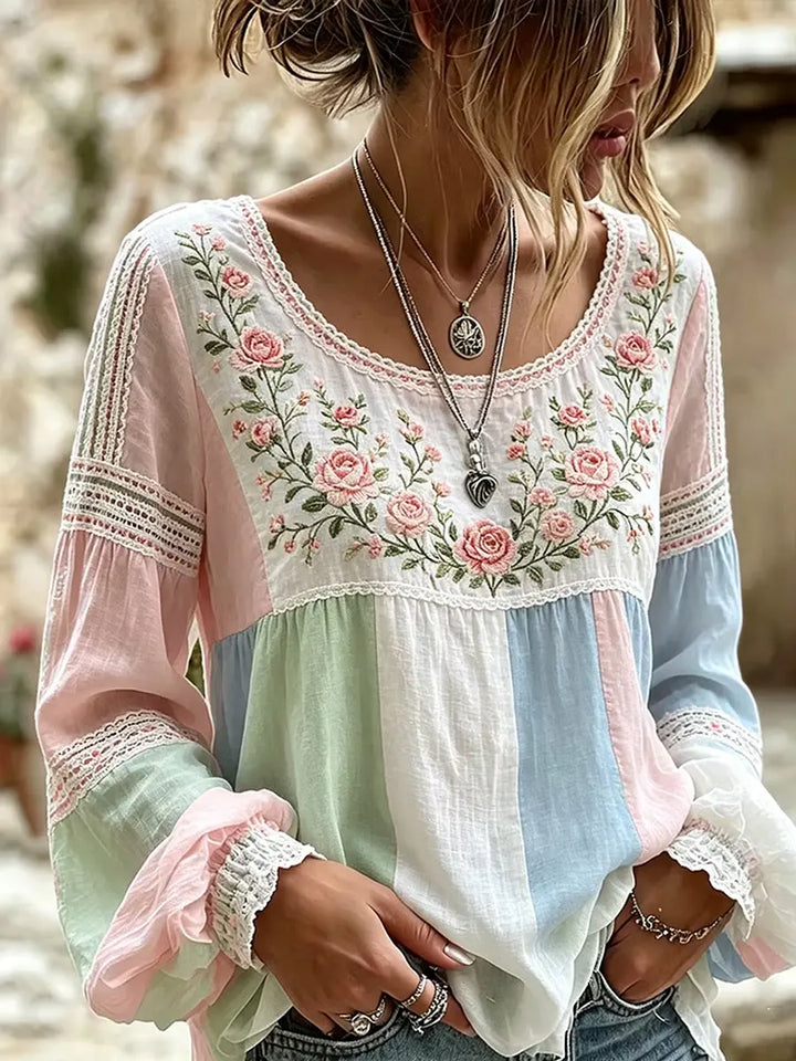 Woman wearing a multicolour floral embroidered long-sleeve blouse outdoors