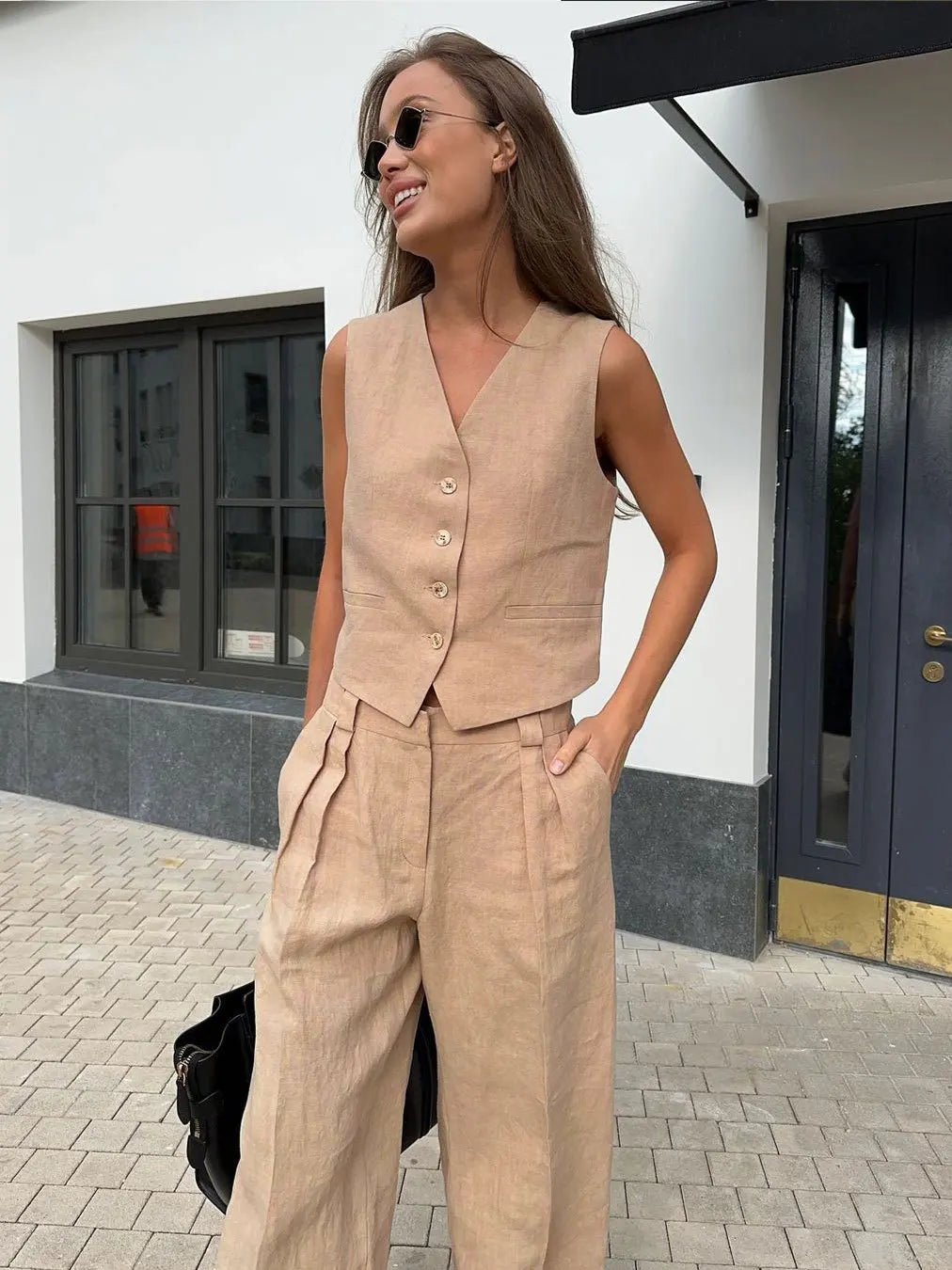 Close-up of the waistband on the flowy pleated trousers