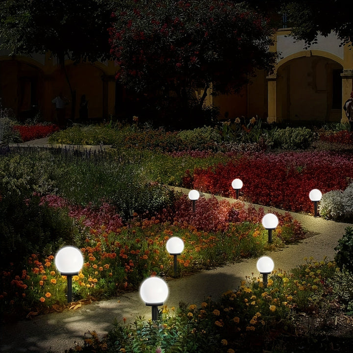 Yard illumination provided by energy-efficient solar garden lights along a walkway.
